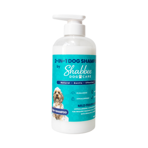 A 500ml bottle of Shabbee Dog Care 2-in-1 Dog Shampoo with a white pump dispenser and a teal label featuring a small dog photo and product details, isolated on a white background.