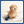 A small fluffy tan dog sitting on a white towel with a blue knitted toy ball beside it, photographed against a clean white studio background with a blue border around the image.