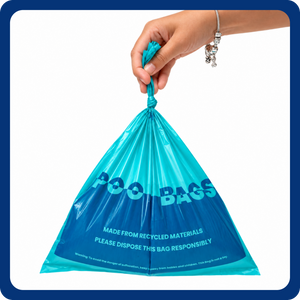 A hand holding a teal and blue plastic poop bag with the words 'POO BAGS' printed on it, set against a plain white background with a blue border.