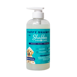 A 500ml bottle of Shabbee Dog Care Puppy Shampoo with a white pump dispenser and a turquoise label featuring a puppy photo, set against a plain white background.
